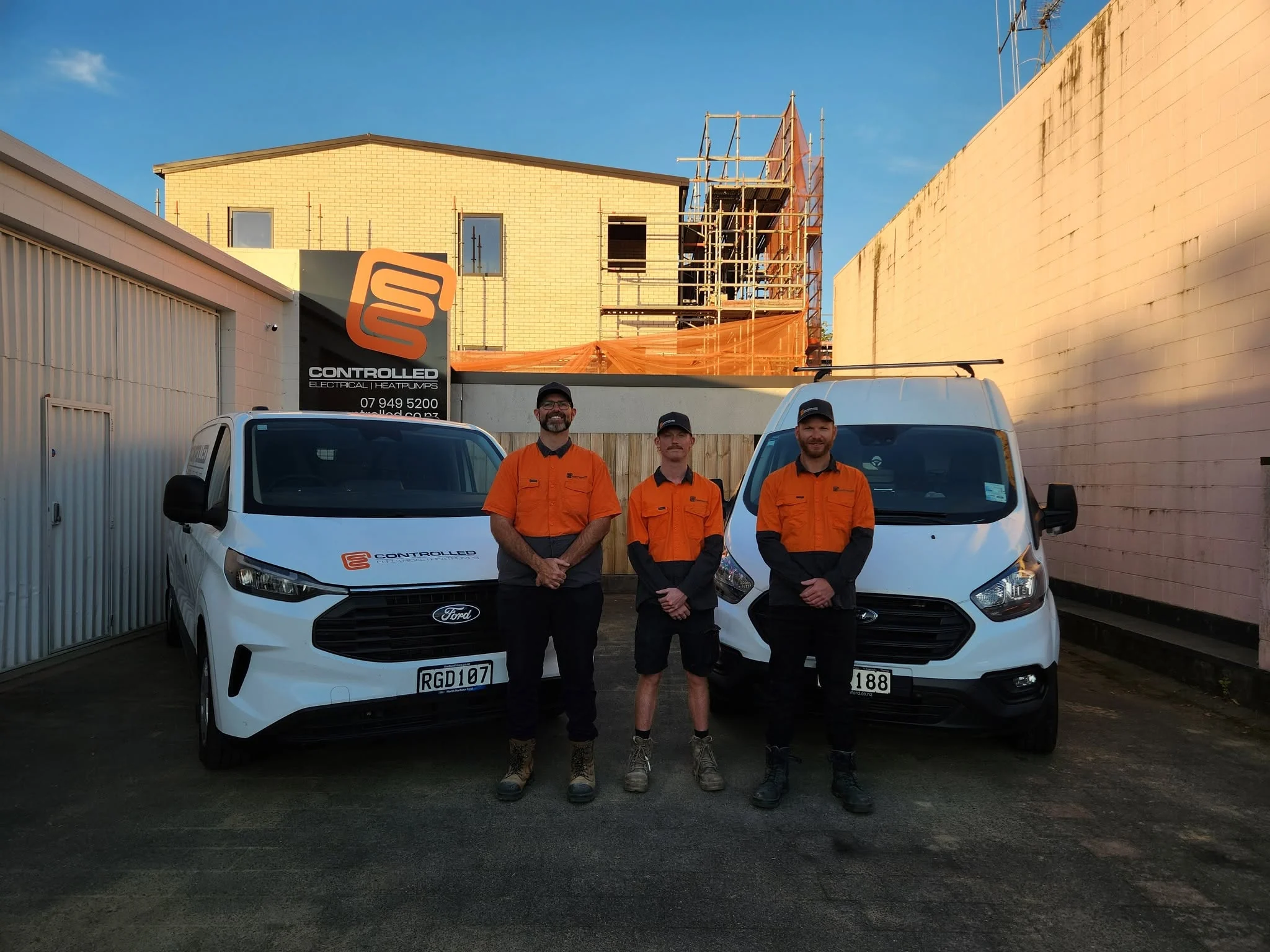 Controlled Electrical team standing with their service vans